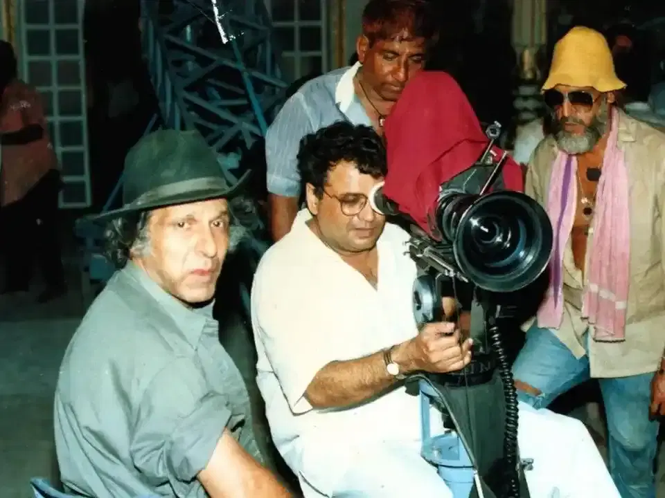 Crew gathered around a film camera on set
