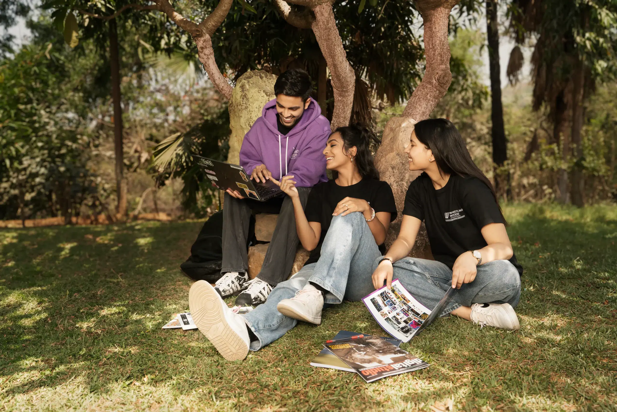 Whistling Woods International students studying together on the campus lawn